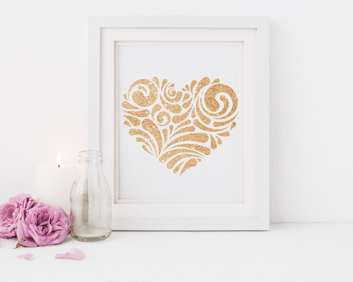 Picture with a golden glitter heart on a white background in white frame.