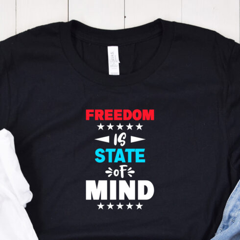 Image of a black t-shirt with elegant "freedom is state of mind" lettering in red and white and turquoise colors. 1 53