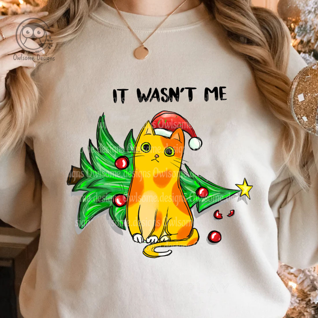 Image of a sweatshirt with a gorgeous print of a cat knocking over a Christmas tree.