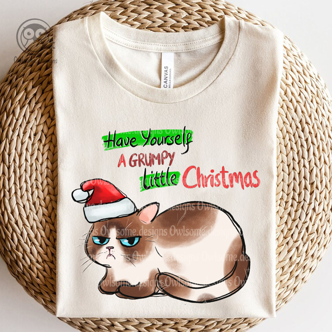 Image of a t-shirt with an enchanting print of a cat in a santa hat.