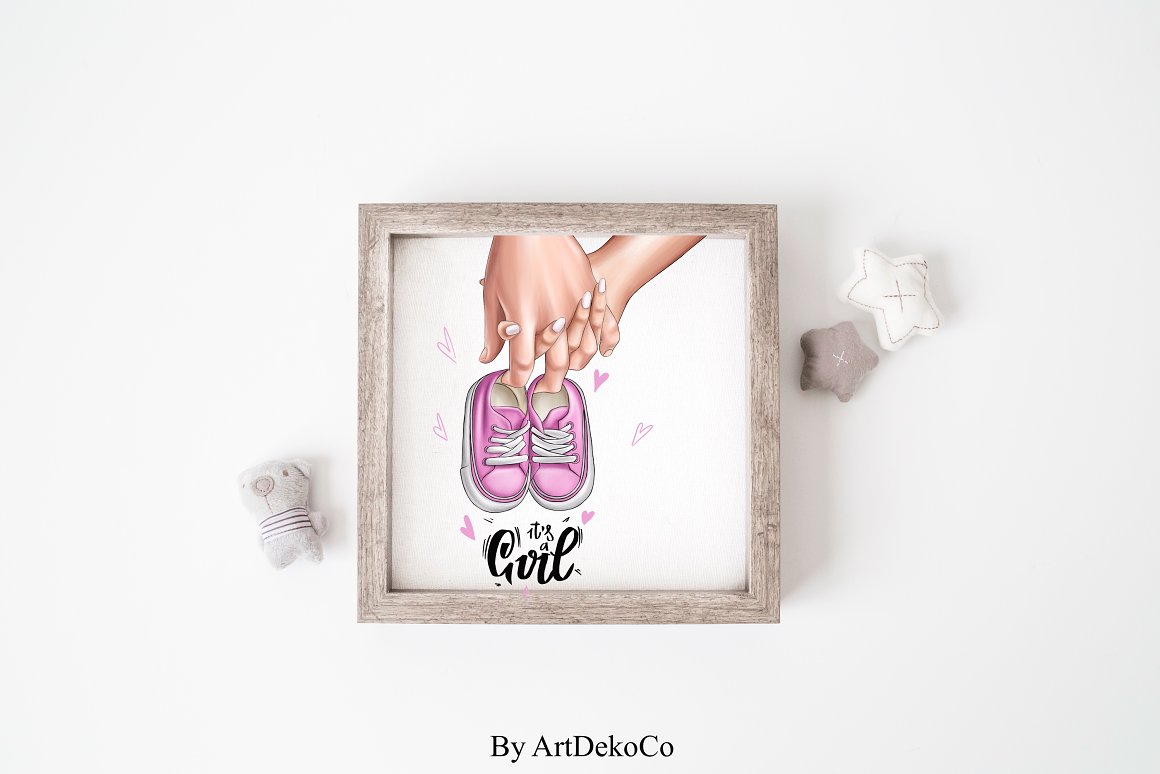 Painting of hands parents-to-be, black lettering and pink shoes in wooden frame.