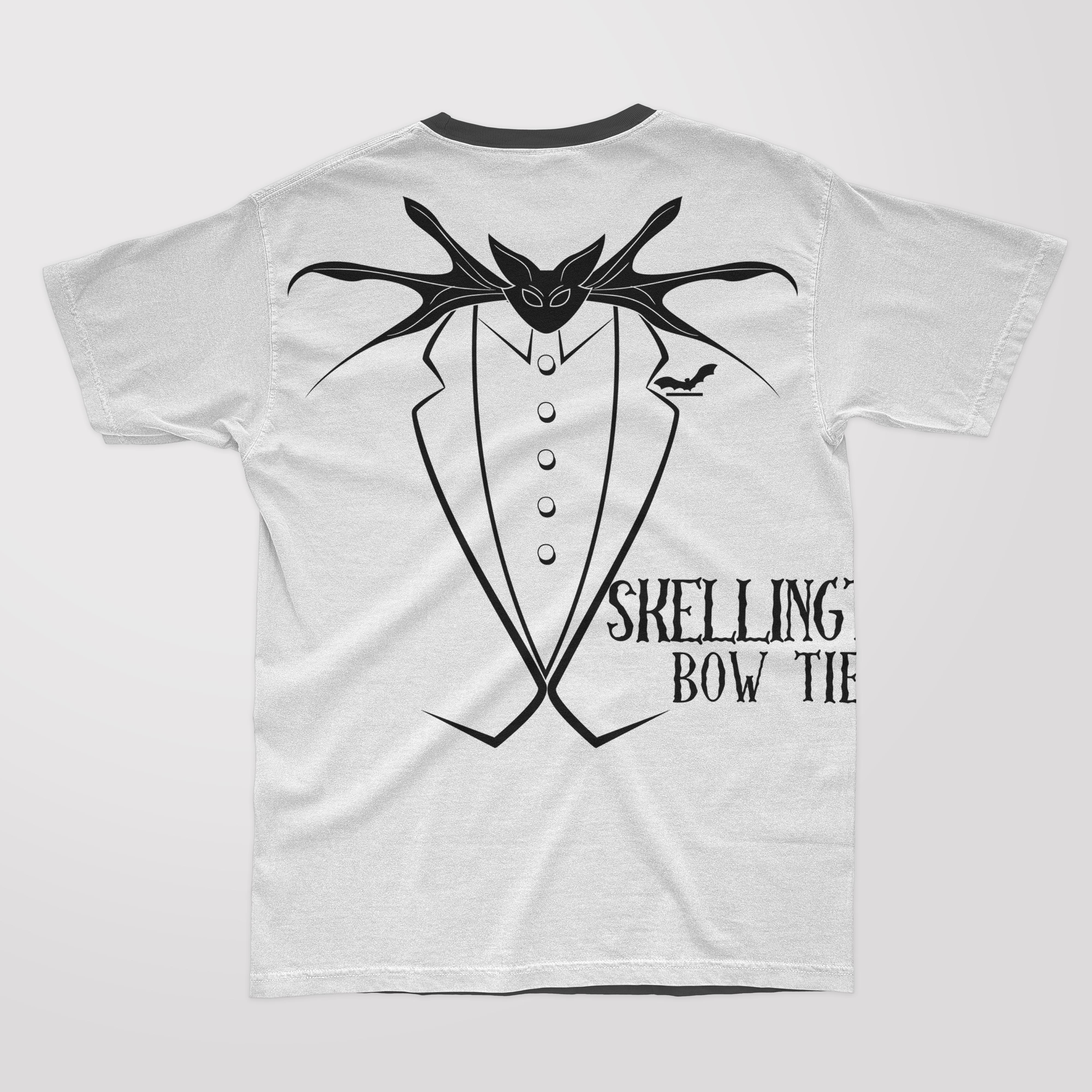 Black lettering "Skelling Bow Tie" and illustration of a skellington bow tie on the white t-shirt with black collar.