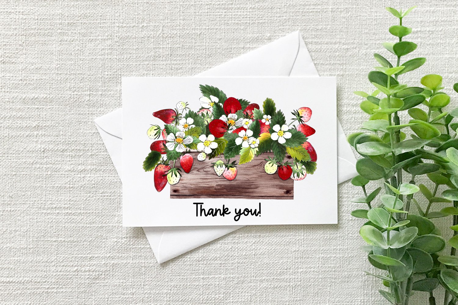 Beautiful card in white envelope and plant.