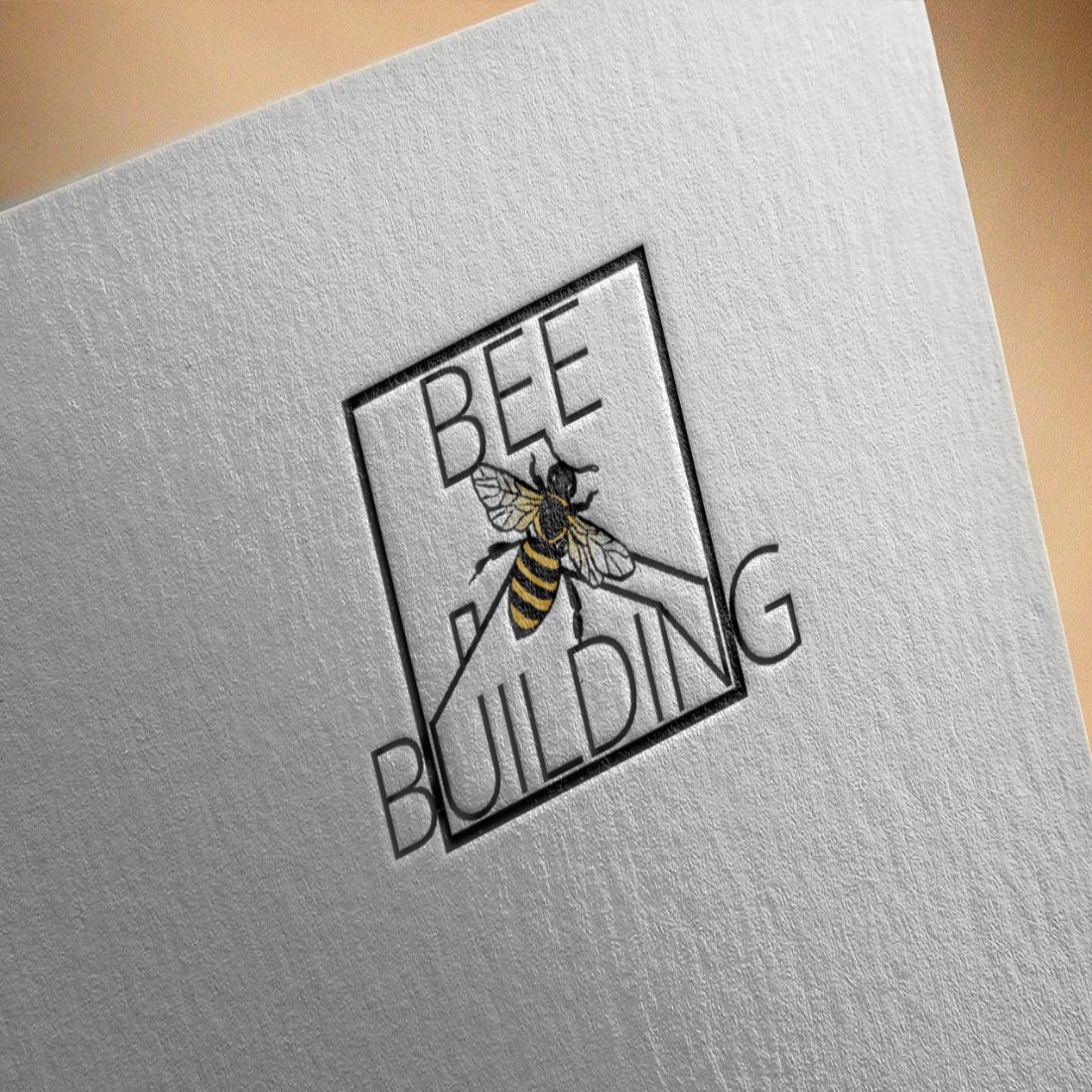 Bee Building Logo Design mockup on paper.