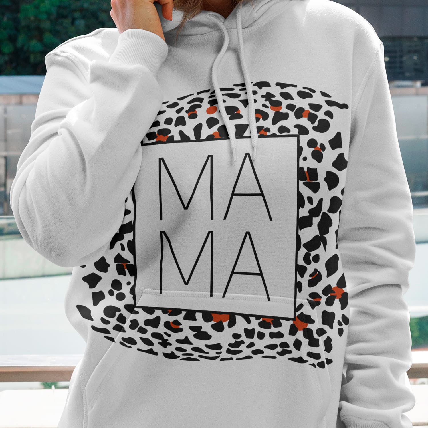 Woman wearing a white hoodie with a leopard print.