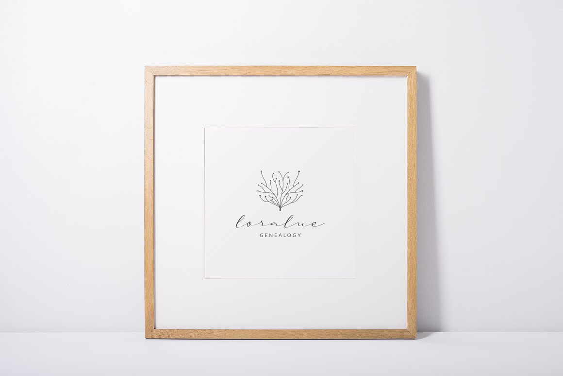White painting in wooden frame with black line art logo "loralue".