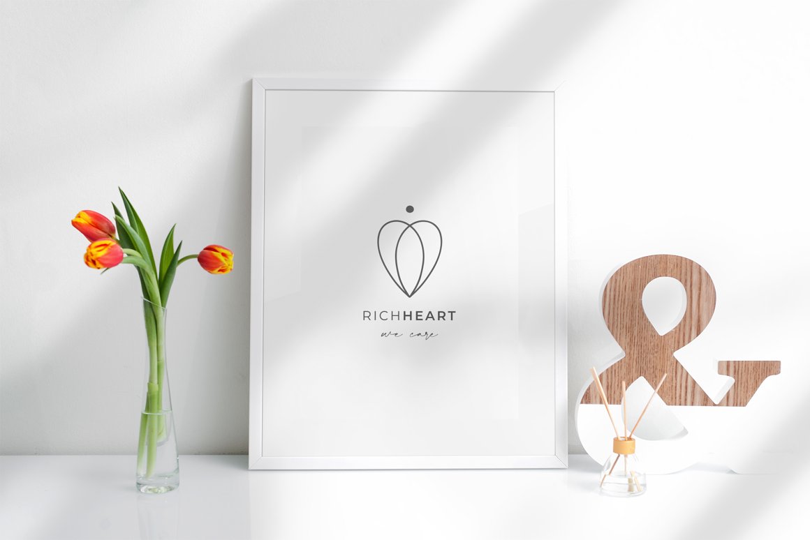 White painting with black line art logo "Richheart" in white frame.