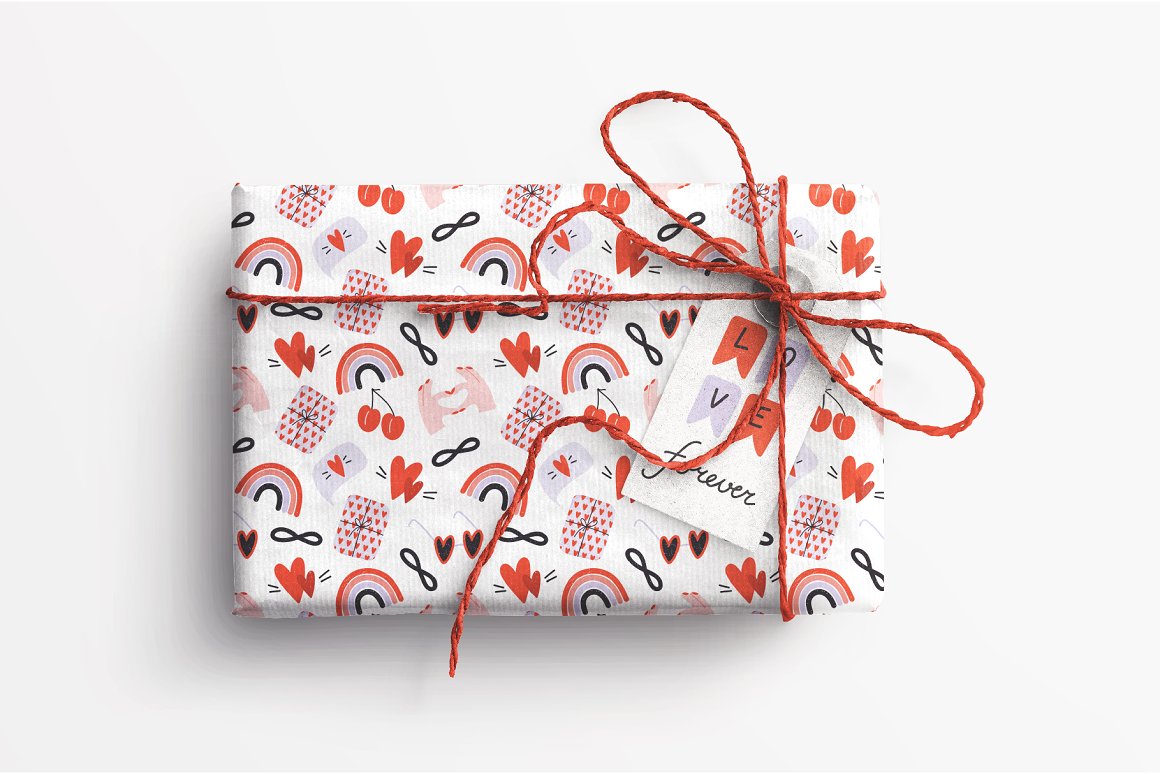 Box in white wrapping paper with pattern of different red valentine's elements.Box in wrapping paper with pattern of different red valentine's elements.
