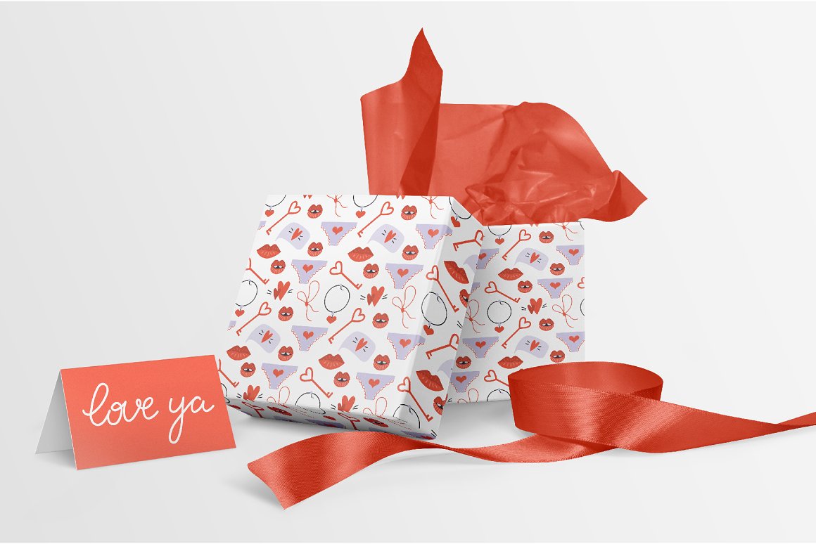 White box with red and gray romantic illlustrations and red paper and greeting card.