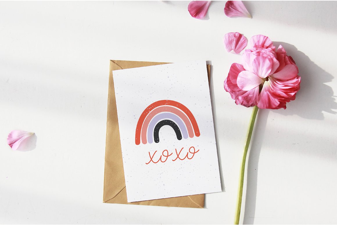 White card with watercolor rainbow illustration and red lettering "XOXO".