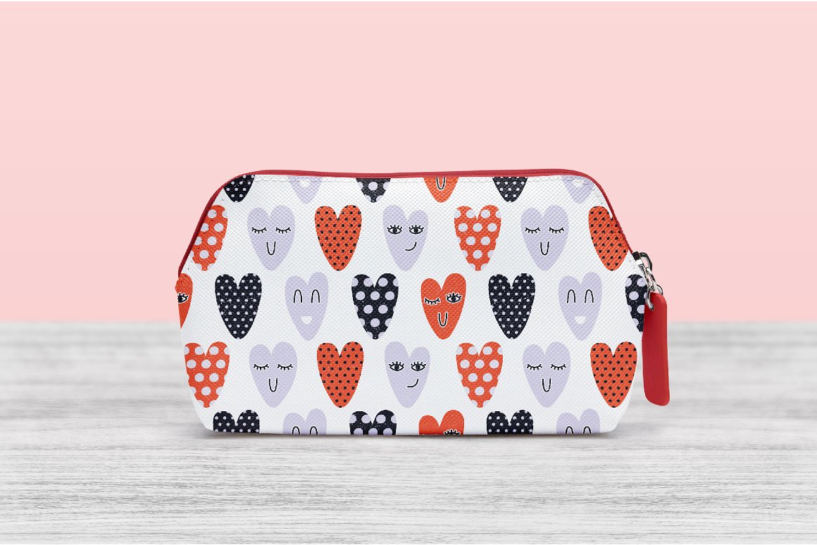 White cosmetic bag with red clasp and patterns of different hearts.