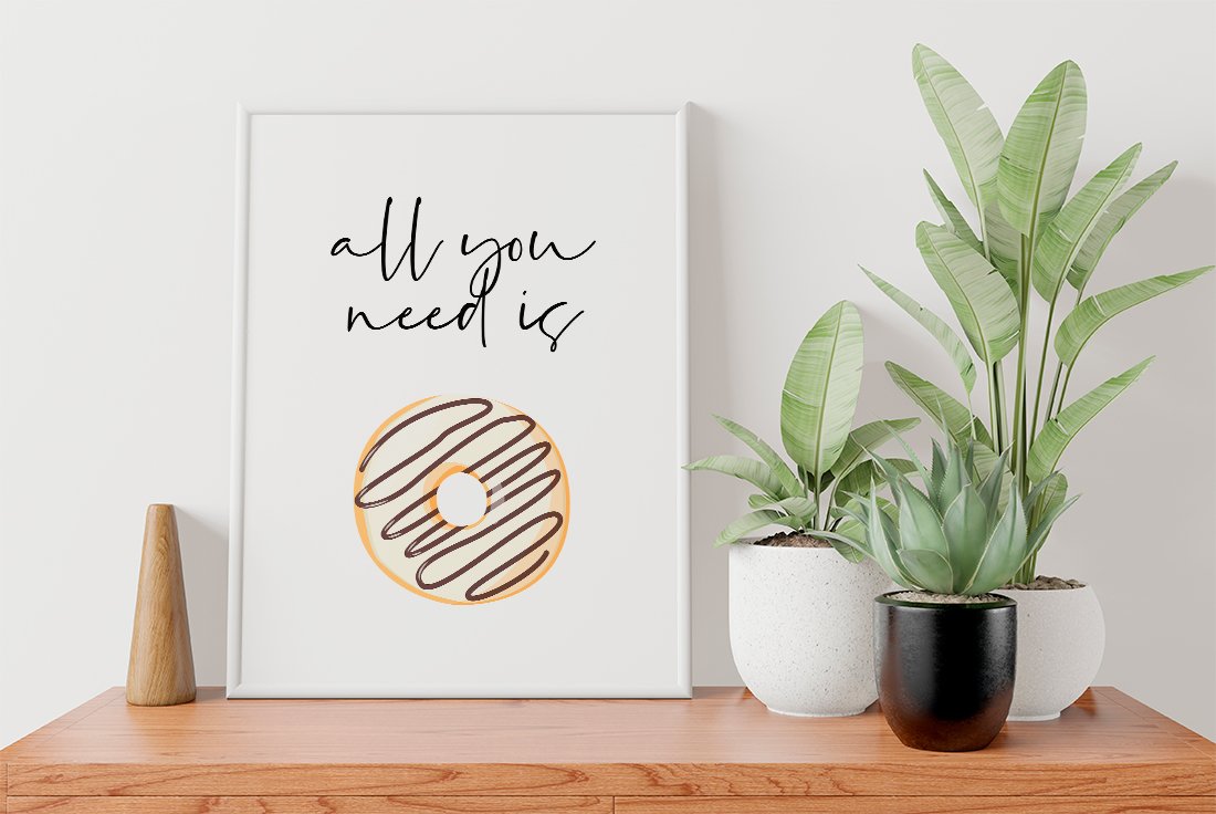 Picture with black lettering "All you need is" and illustration of a donut in white frame on a white background.