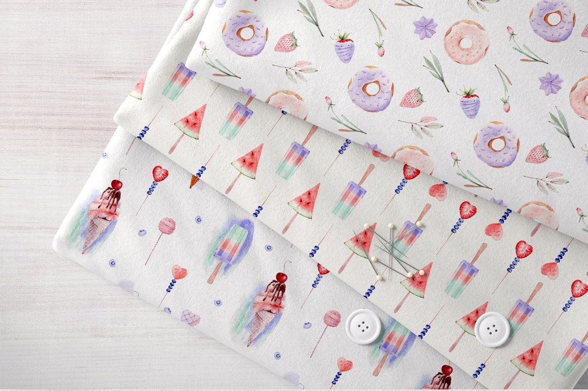 A set of 3 different patterned fabric rolls with illustrations of sweets.