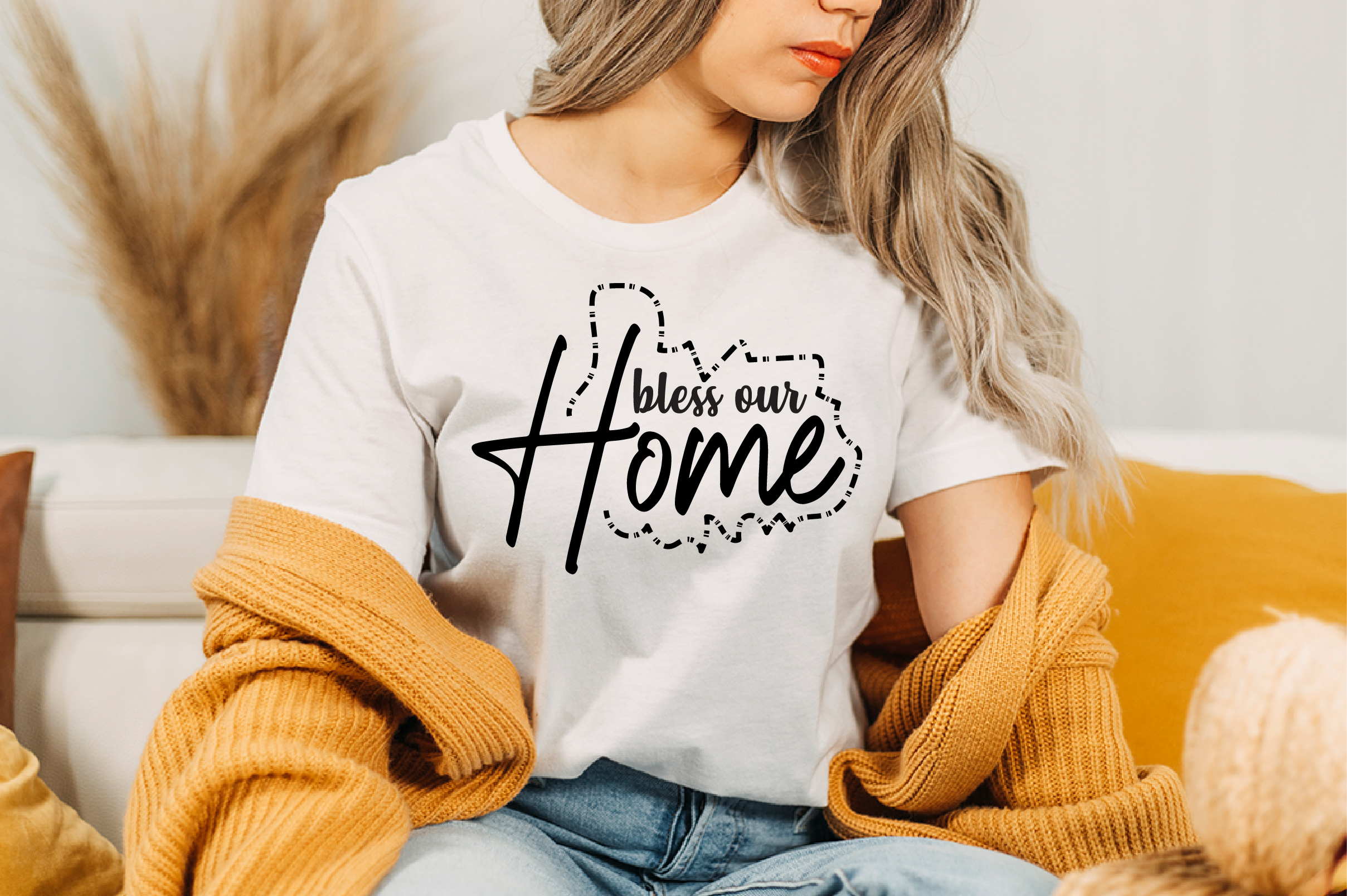 Image of a white t-shirt with a charming black slogan Bless Our Home.