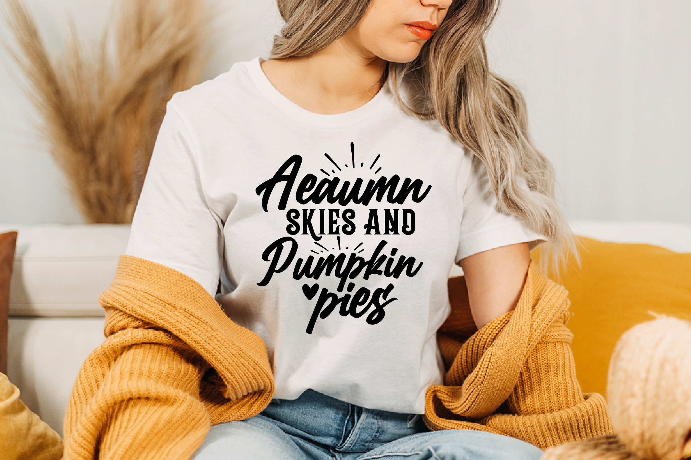 Image of a white T-shirt with a unique black slogan Autumn Skies And Pumpkin Pies.