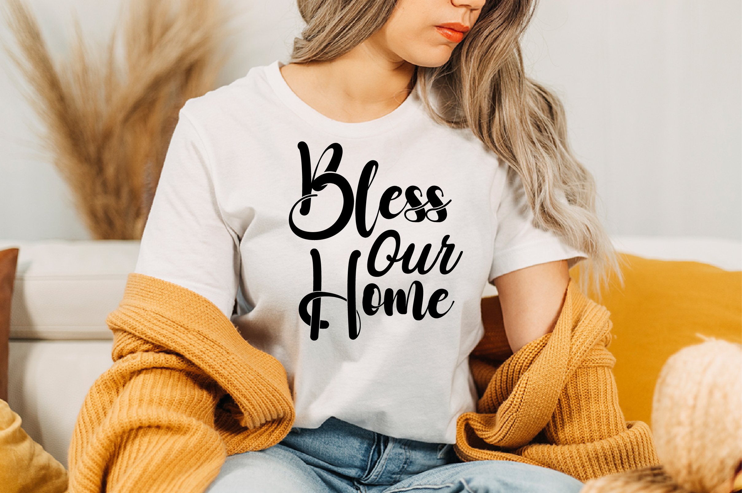 Image of a white T-shirt with a unique black slogan Bless Our Home.