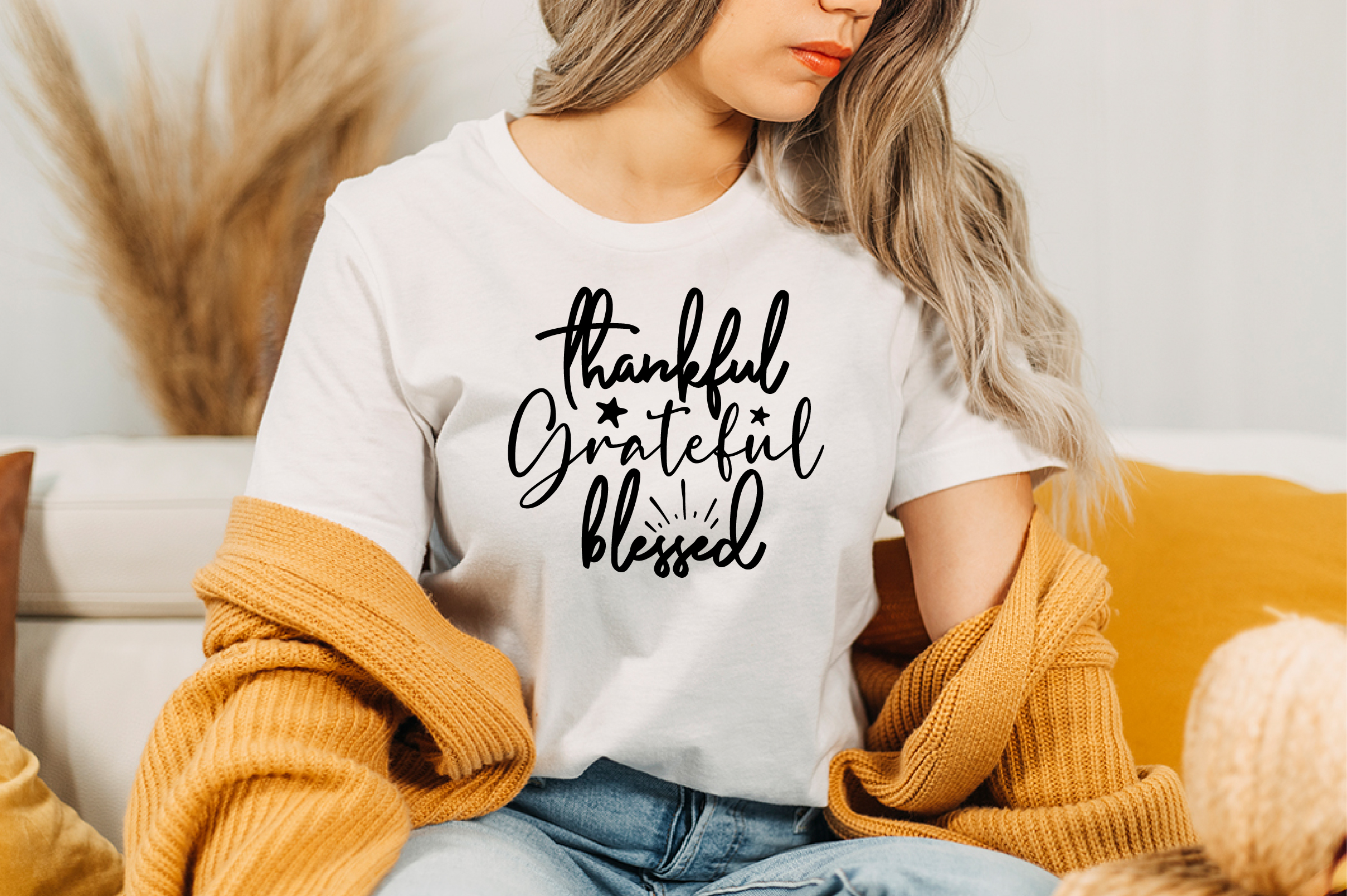 Image of a white T-shirt with an irresistible black slogan Thankful Grateful Blessed.