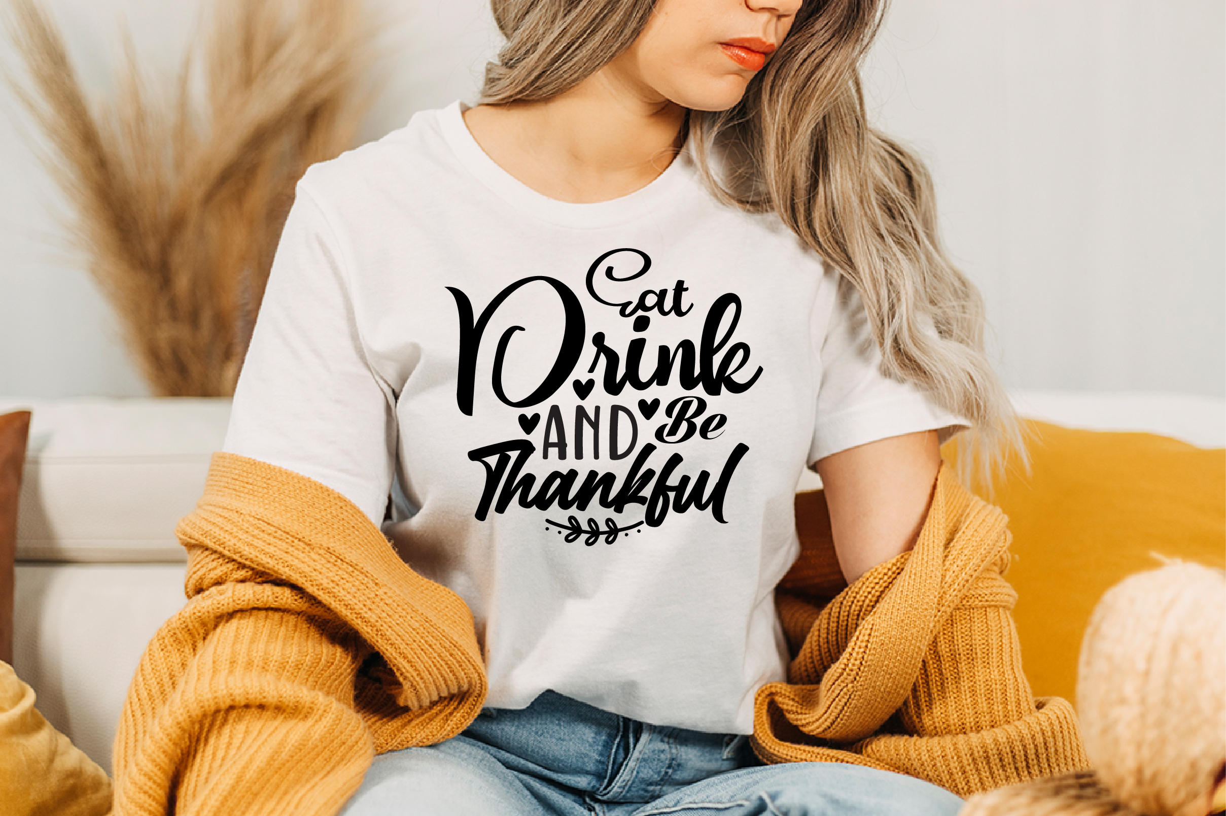 Image of a white T-shirt with a charming black inscription Eat Drink And Be Thankful.