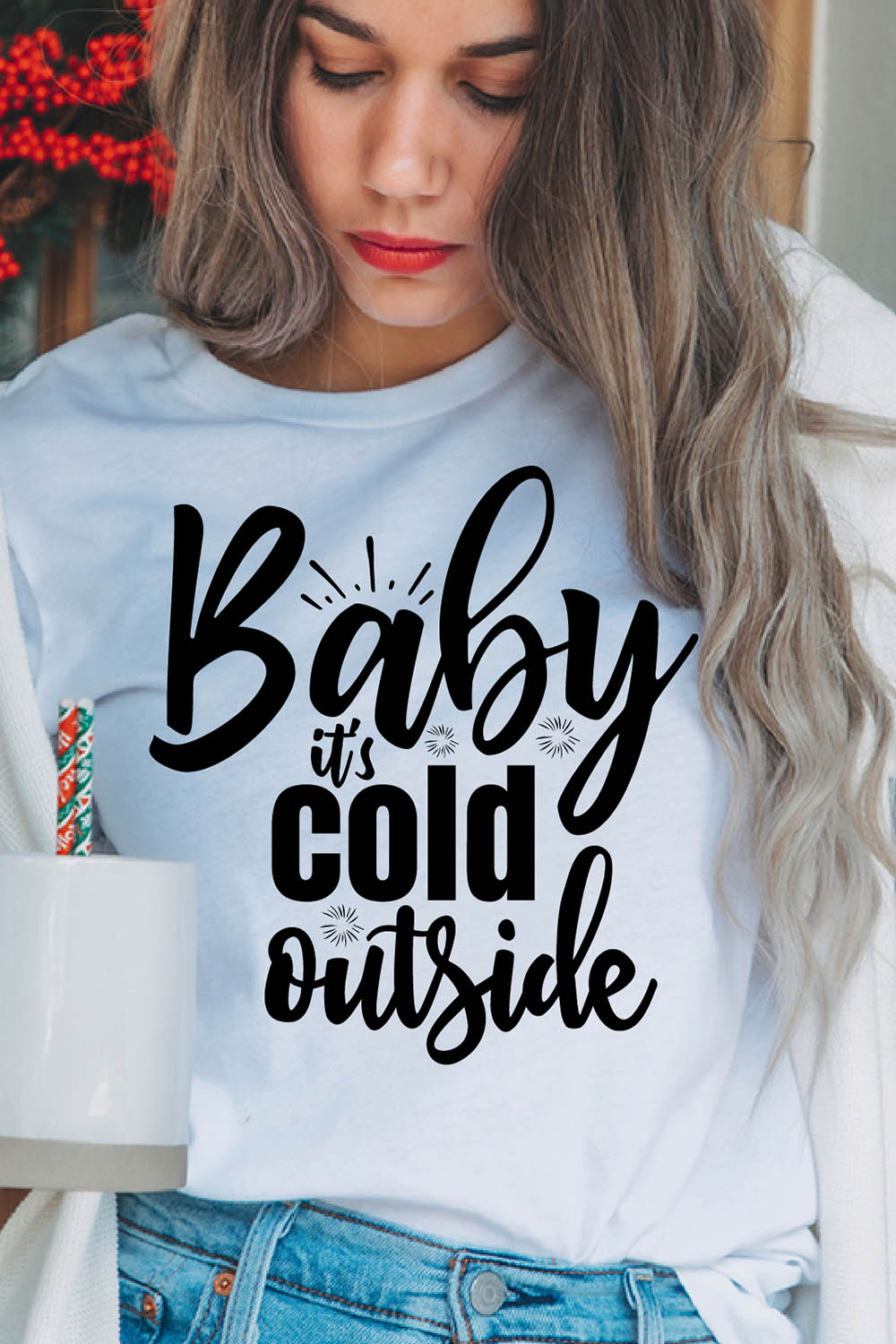 Image of a girl in a white t-shirt with an enchanting inscription "Baby it's cold outside".