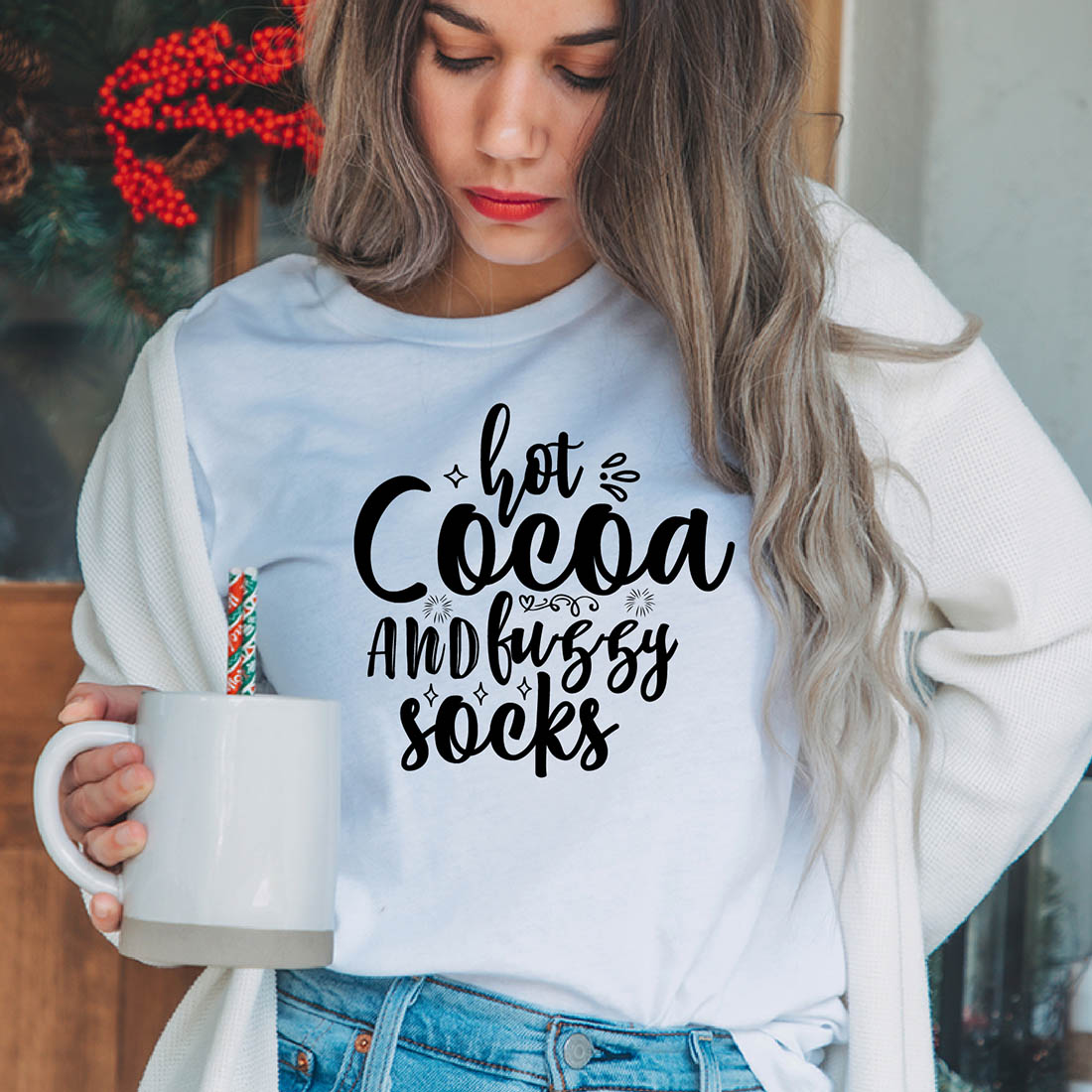 Image of a girl in a white T-shirt with a colorful inscription "Hot Cocoa And Fuzzy Socks".