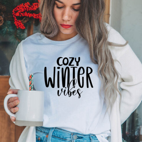 Image of a girl in a white t-shirt with an exquisite inscription "cozy winter vibes".