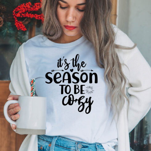 Image of a girl in a white t-shirt with an irresistible slogan "It's the season to be cozy".