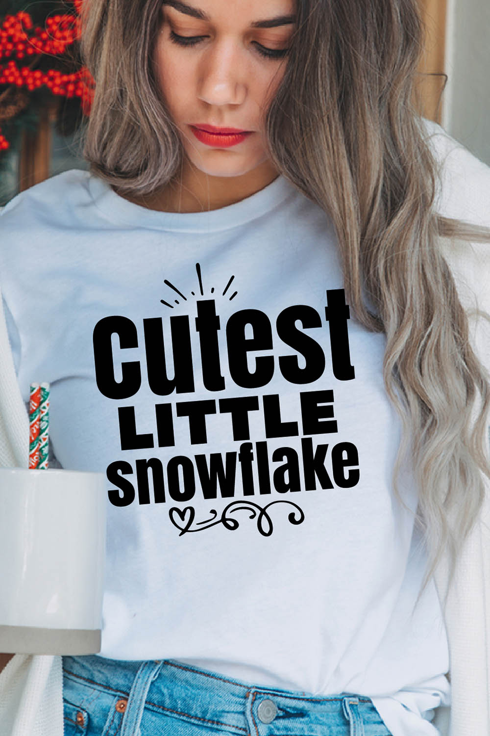 Image of a girl in a white T-shirt with a colorful inscription "cutest little snowflake".