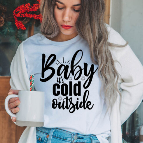 Image of a girl in a white T-shirt with a beautiful inscription "Baby it's cold outside".