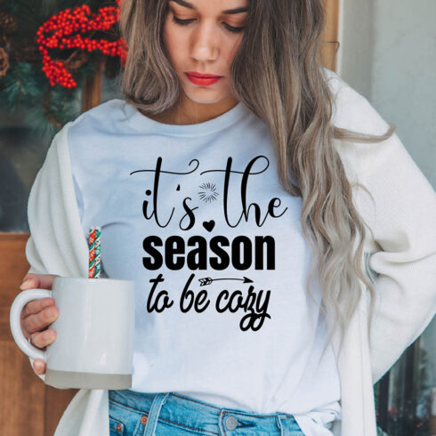 Image of a girl in a white t-shirt with a enchanting inscription "It's the season to be cozy".