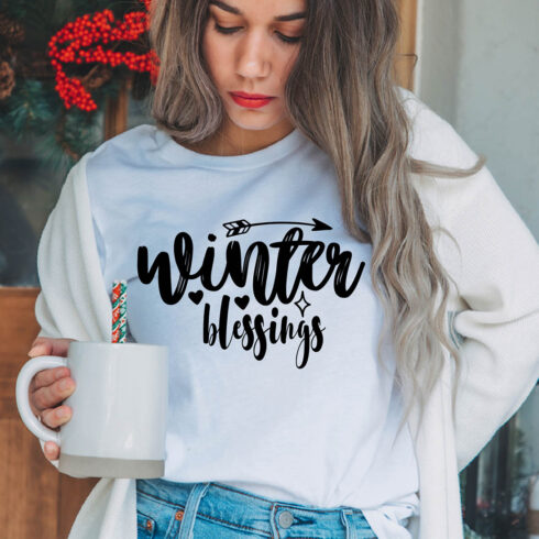 Image of a girl in a white t-shirt with a charming inscription "winter blessings".