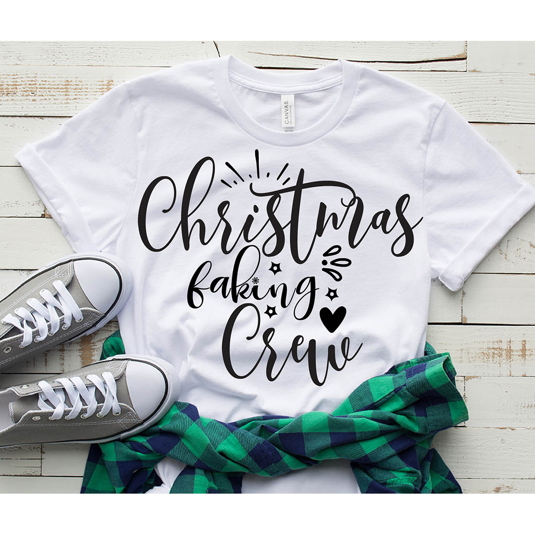 Picture of a white t-shirt with colorful black "Christmas Baking Crew" lettering.