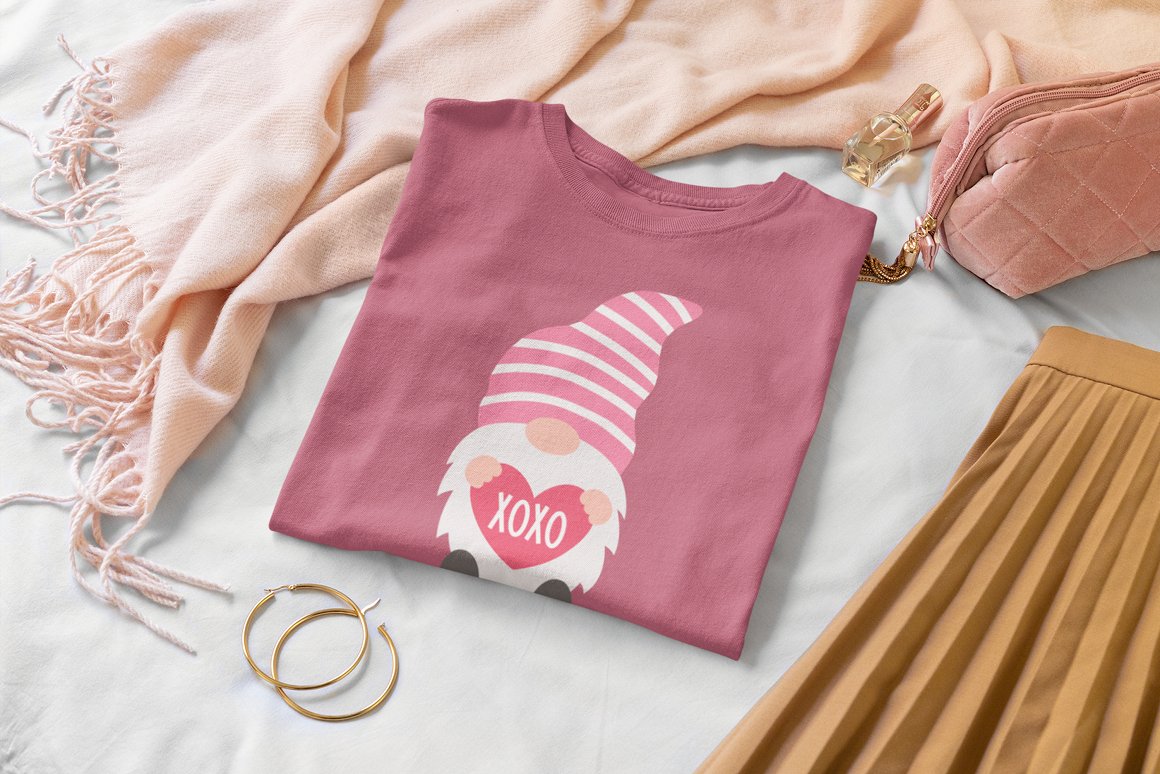 A pink t-shirt with illustration of a gnome and white lettering "XOXO".