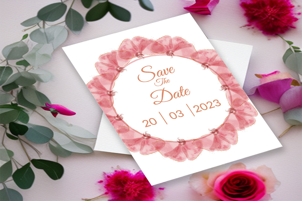 Image with unique wedding invitation card in pink tones and flowers.