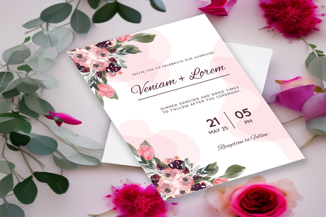 Image of a colorful wedding invitation in combination with flowers and leaves.