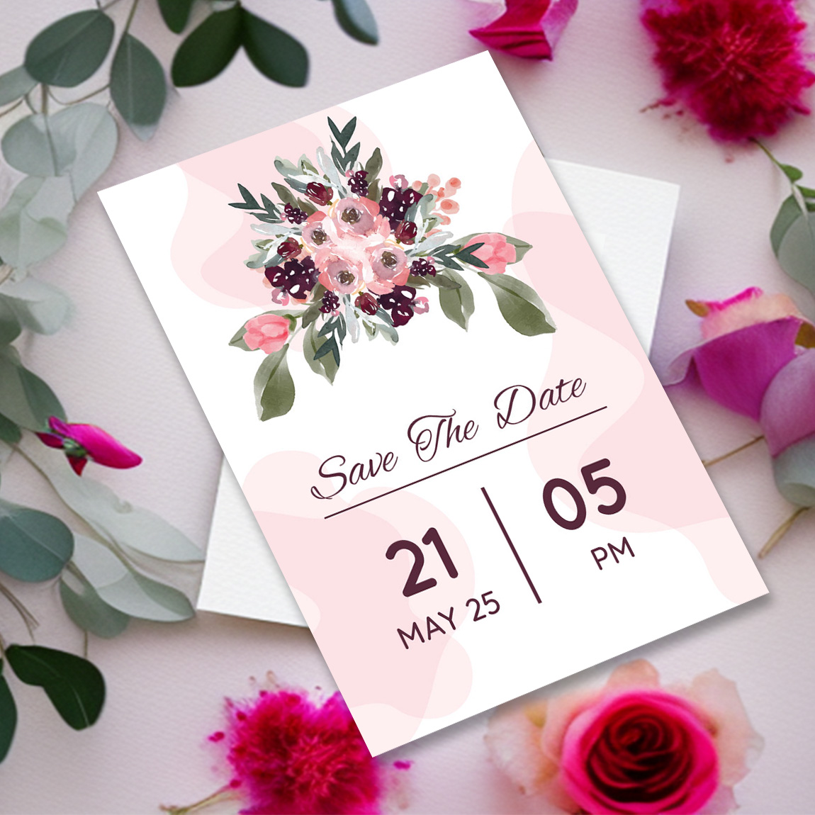 Image of an exquisite wedding invitation in combination with flowers and leaves.