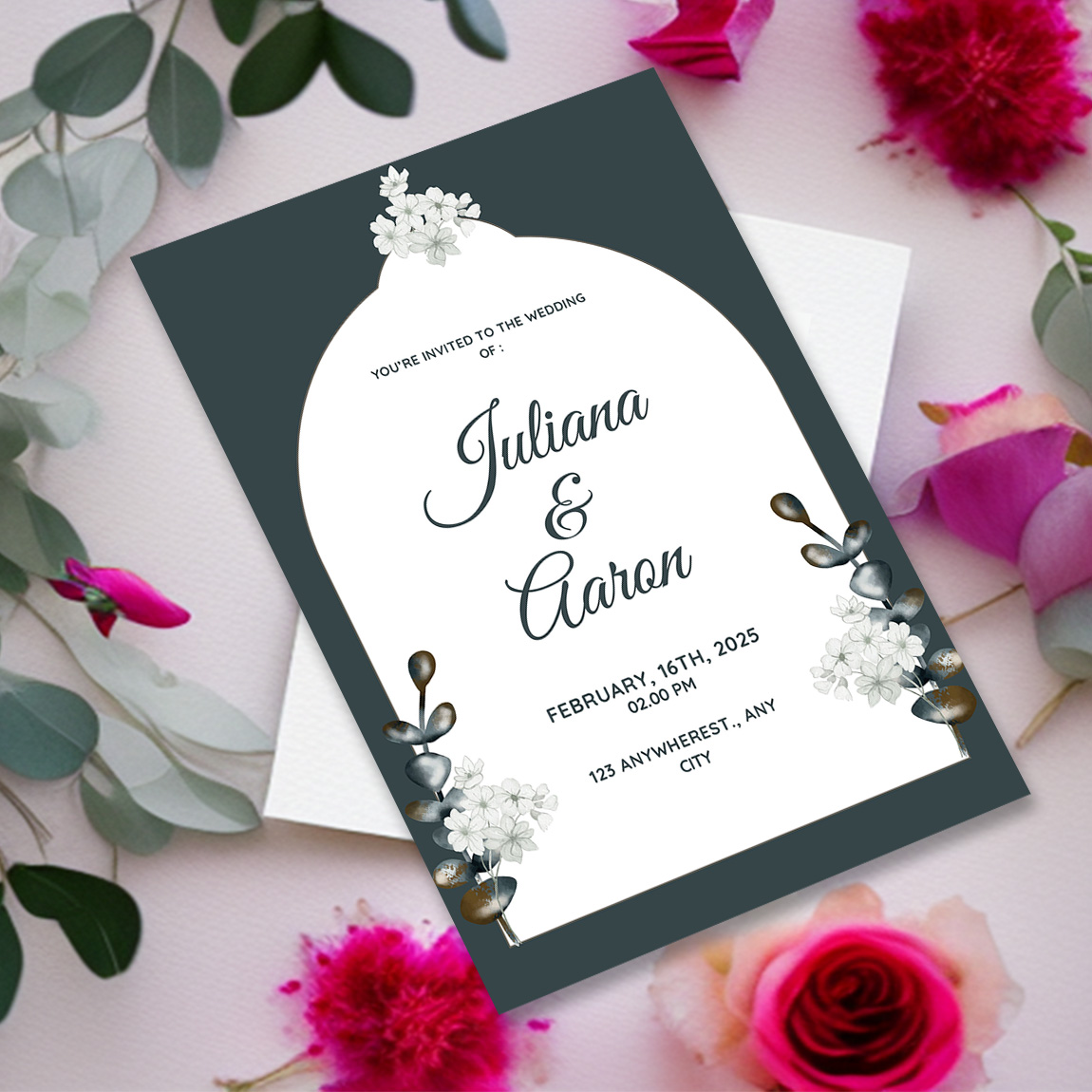 Image with gorgeous wedding invitation card in dark green and flowers.