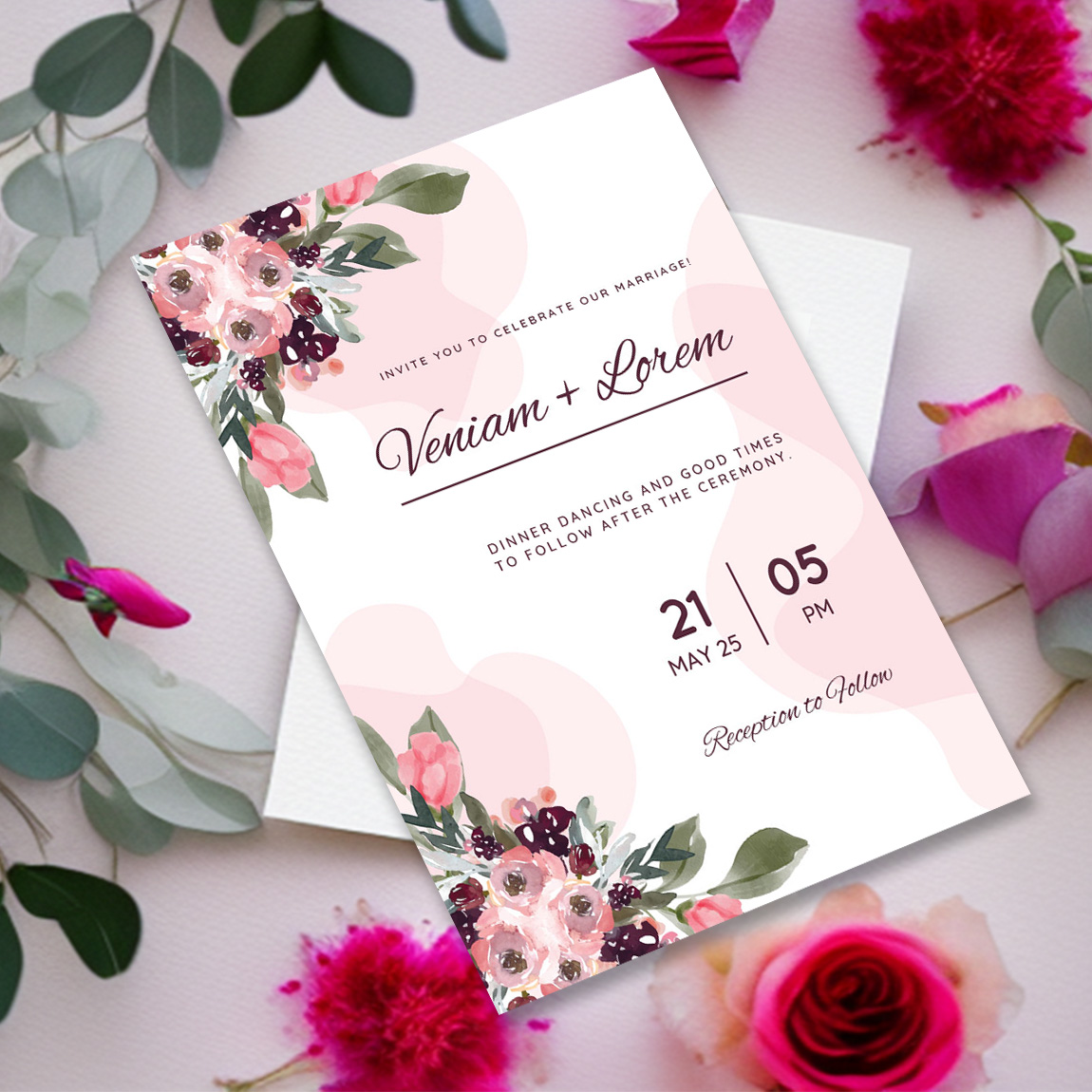 Image of a gorgeous wedding invitation in combination with flowers and leaves.