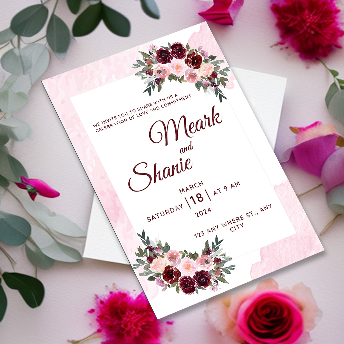 Image with beautiful wedding invitation in pink tone and flowers.