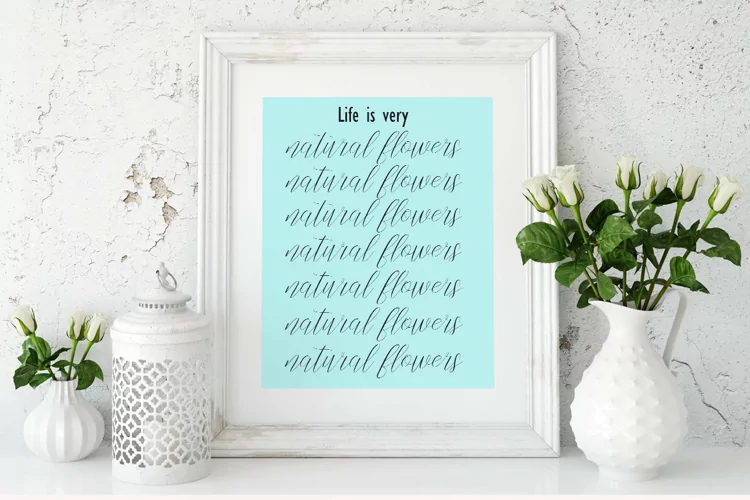 Black lettering “Life is very” and different calligraphy lettering “natural flowers” on a light blue background.