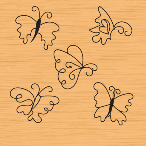 Four butterflies on a wooden background.