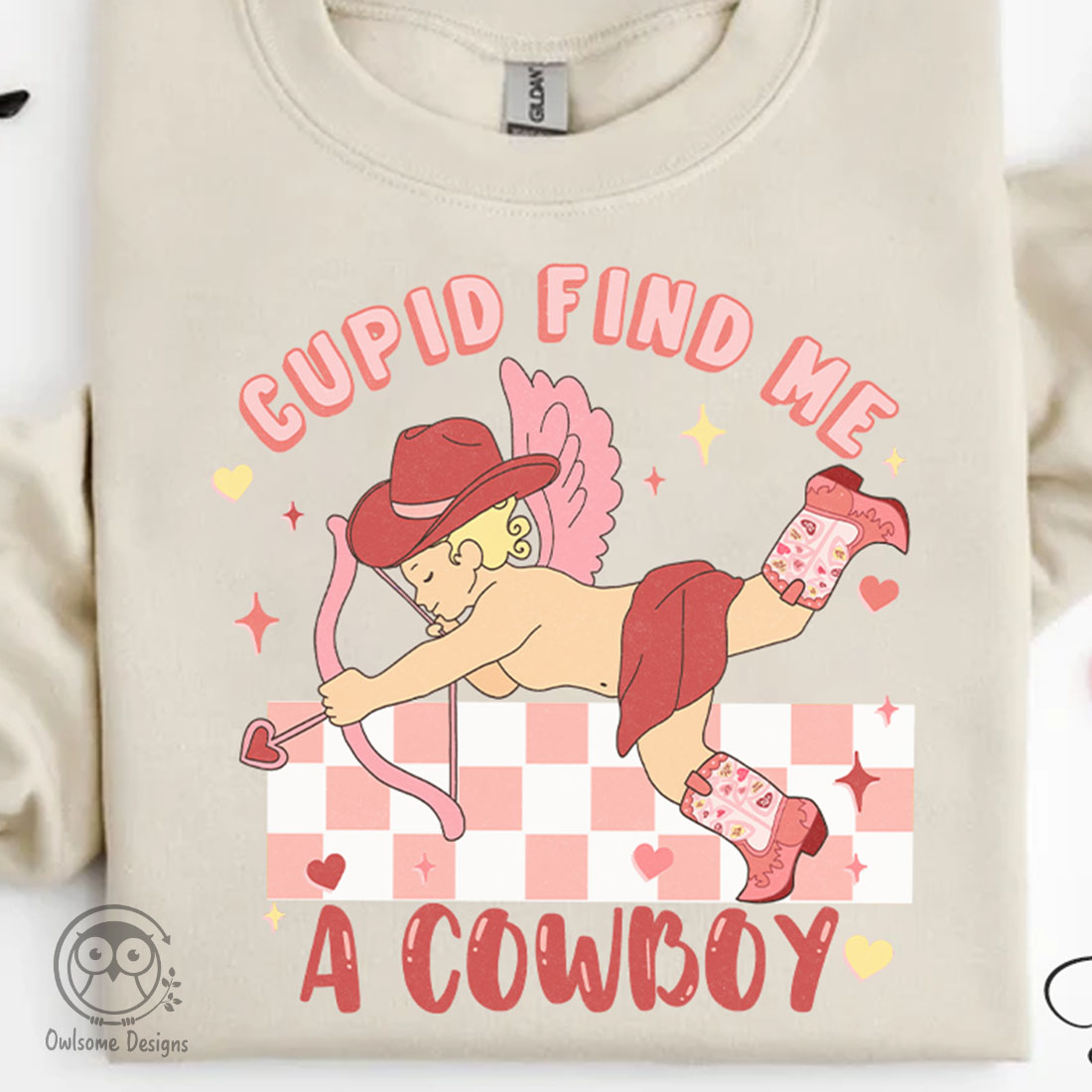 Image of t-shirt with enchanting print of Cupid in cowboy hat.