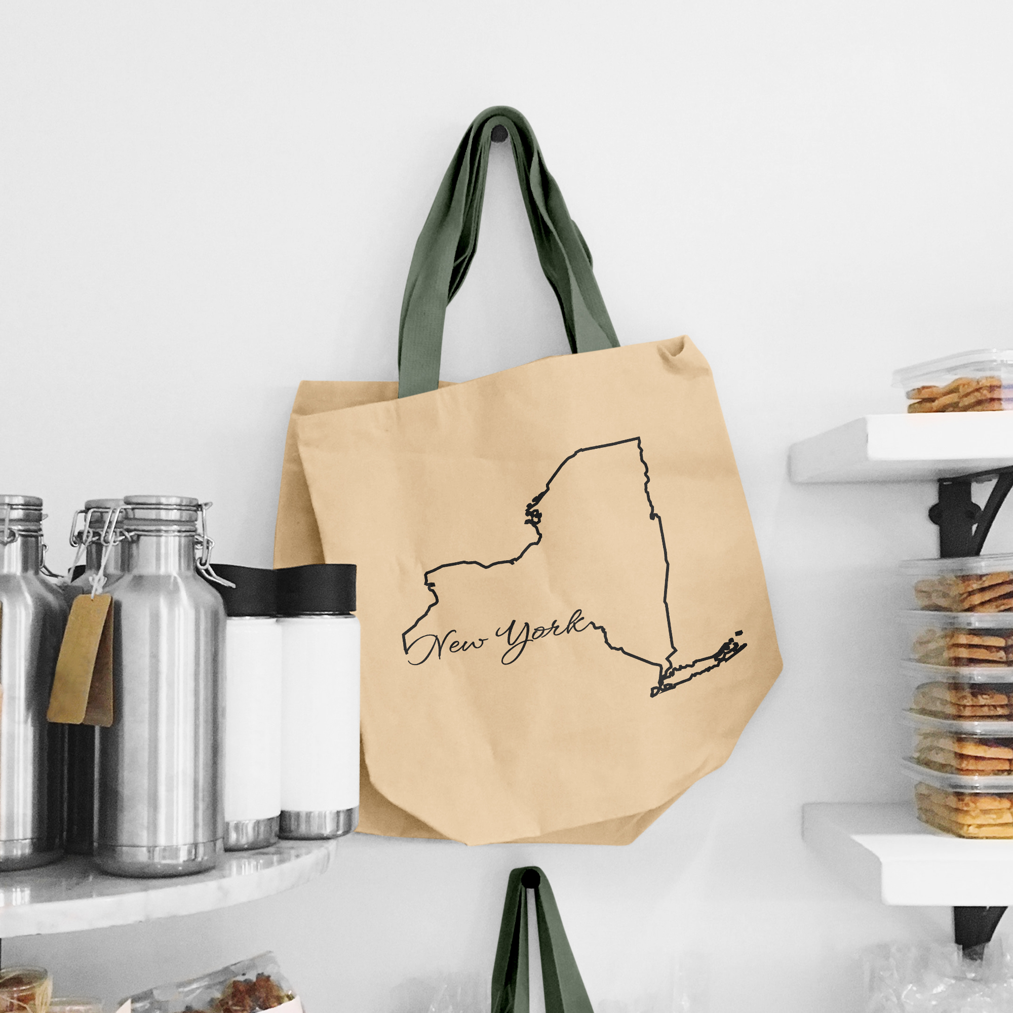 Black illustration of map of New York on the beige shopping bag with dirty green handle.