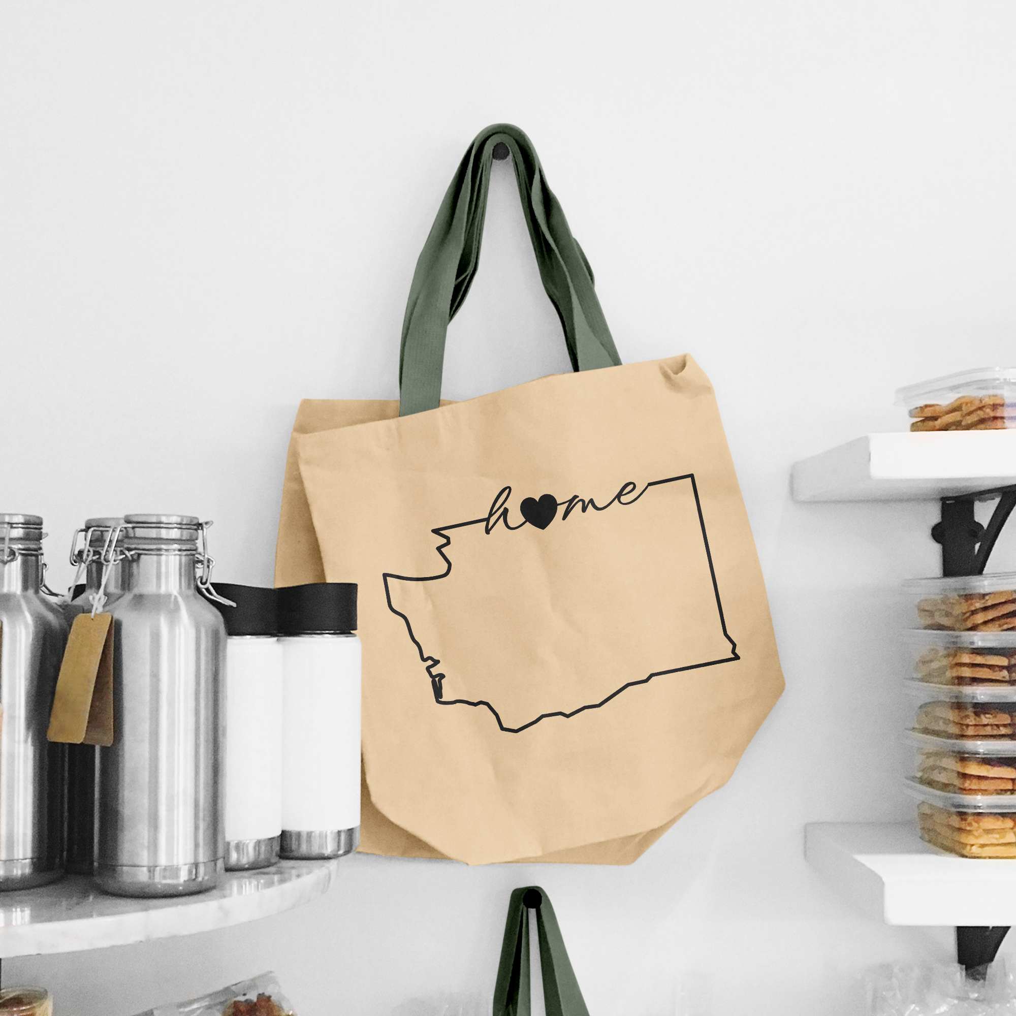 Black illustration of map of Washington on the beige shopping bag with dirty green handle.
