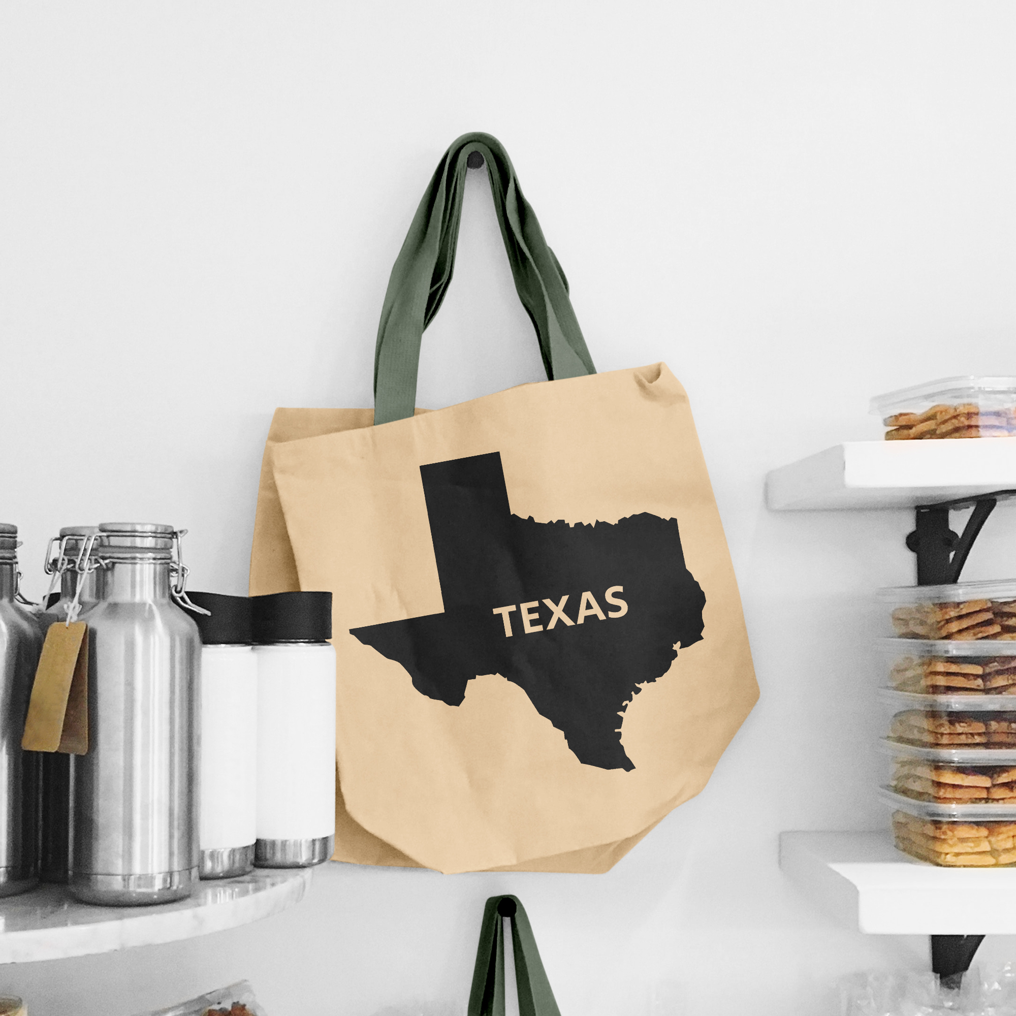 Black illustration of map of Texas and lettering "Texas" on the beige shopping bag with dirty green handle.