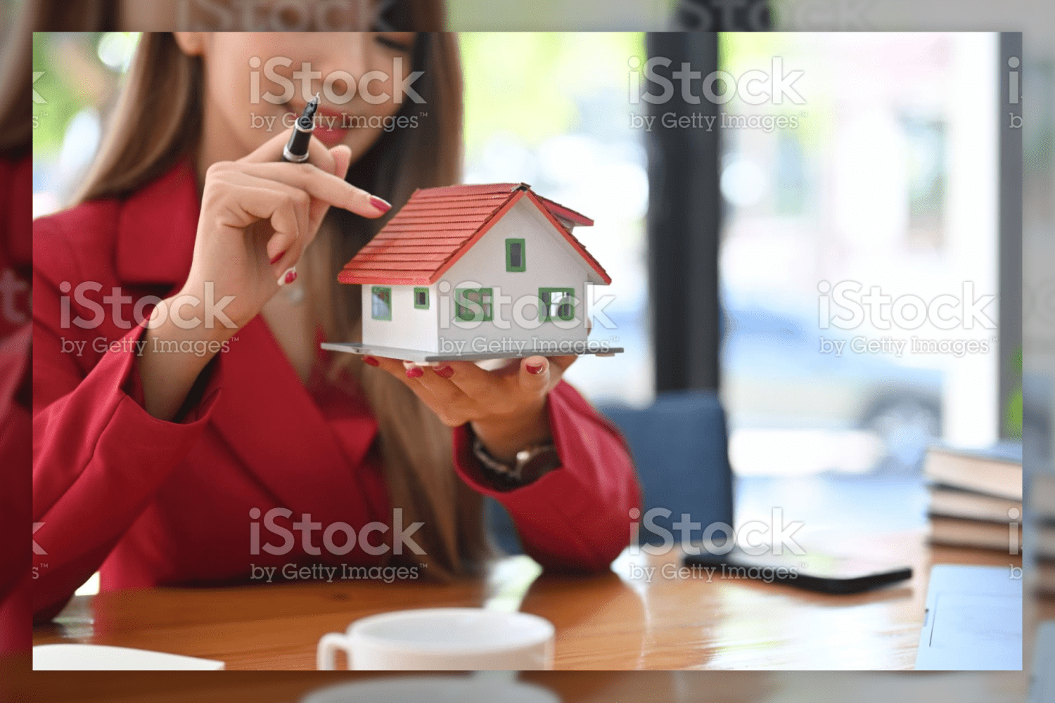 49 smiling asian woman holding small house model 45