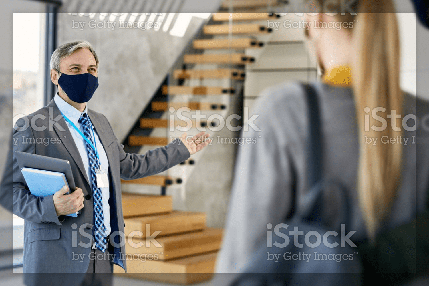 50 real estate agent wearing face mask while showing new apartment 734