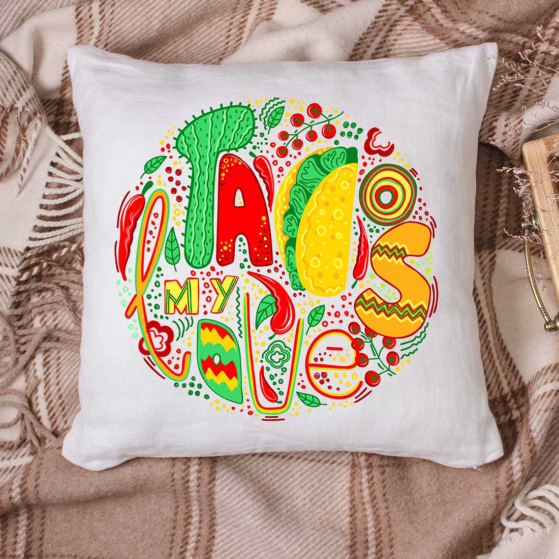 White pillow with multicolor Mexican graphic.
