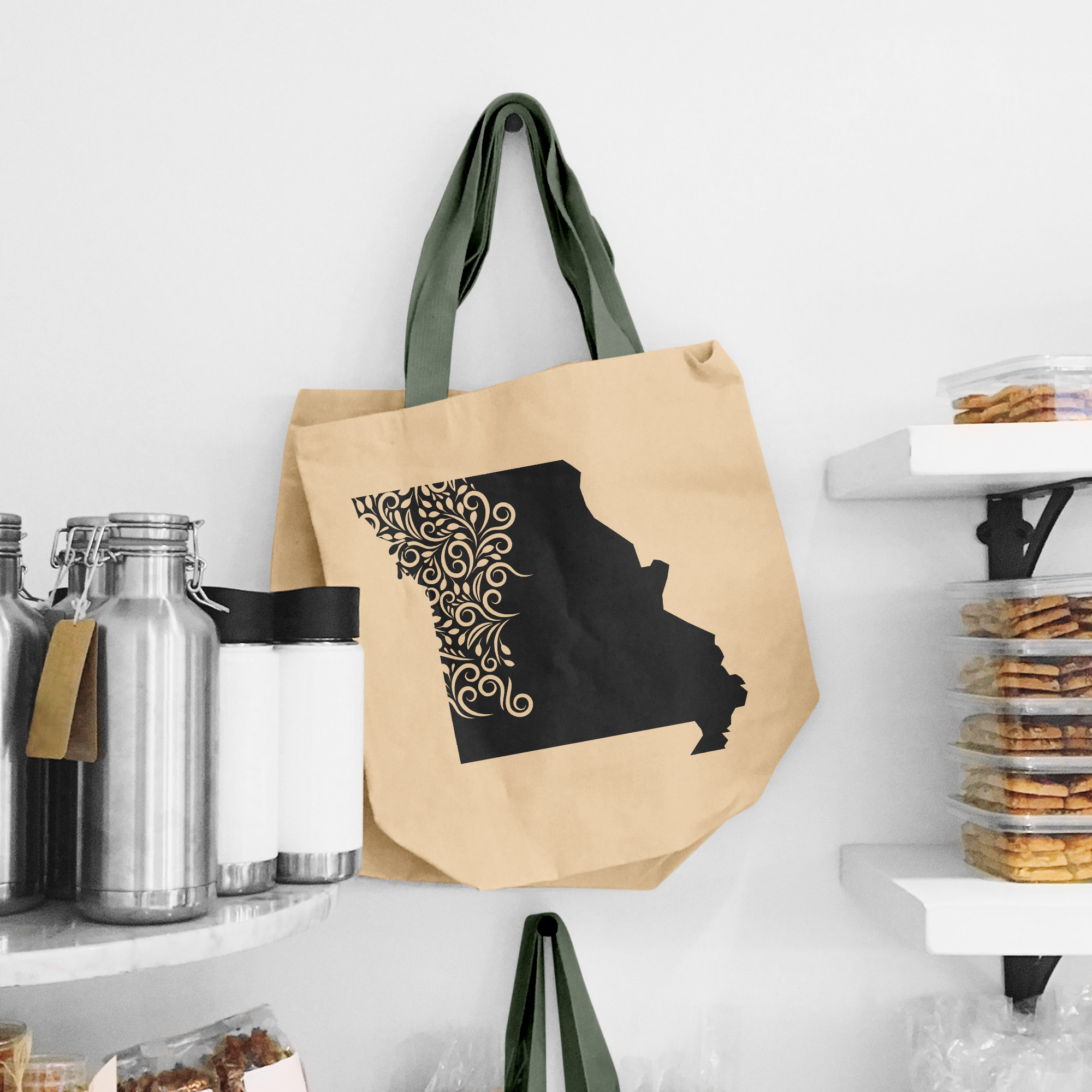 Black illustration of map of Missouri on the beige shopping bag with dirty green handle.