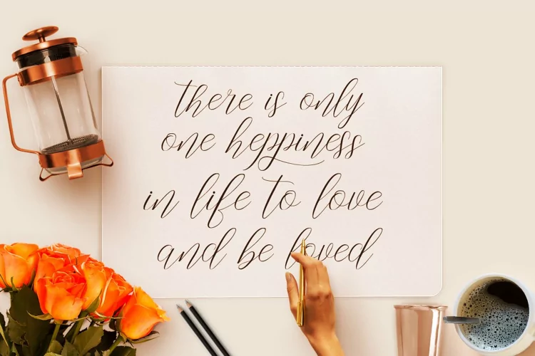 Lettering “There is only one happiness in life to love and be loved” in calligraphy.