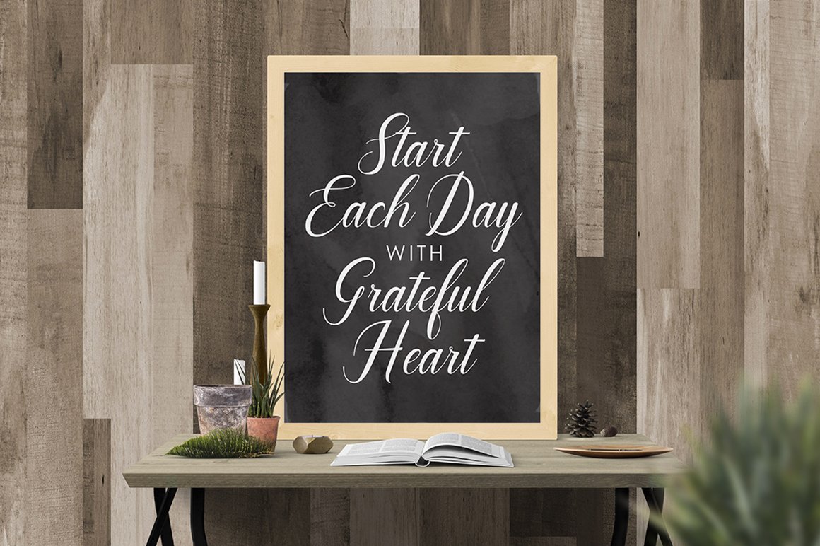 Dark gray picture with white lettering in wooden frame.